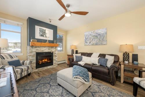 a living room with a couch and a fireplace at Fraser Crossing 3302 in Winter Park
