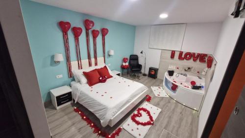 a bedroom with a bed with red pillows at Serendipia 52 in Suances