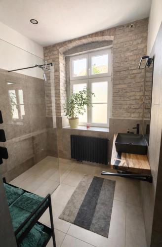 a bathroom with a glass shower and a sink at Casa Roberto, Apartment 1 in Mariazell