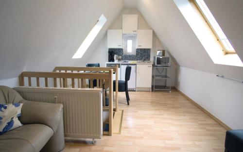 a living room with a couch and a kitchen at Luv Lee Duhnen 09 in Cuxhaven
