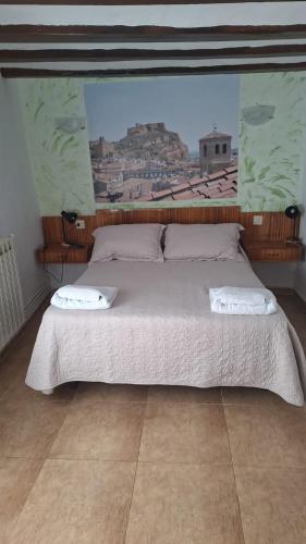 a bedroom with a large bed with two pillows on it at Pensiòn ISASA in Arnedo