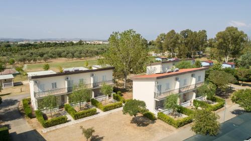 an aerial view of a building with trees and bushes at Village Due Elle in Schiavonea
