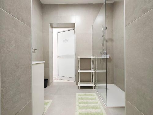 a bathroom with a shower and a glass door at Dar Marija in Valletta