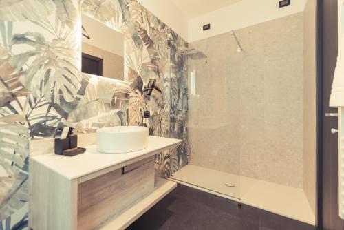 a bathroom with a sink and a shower at Palazzo Digiuseppe Rooms in Martina Franca