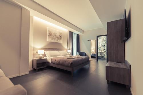 a bedroom with a bed and a chair in a room at Palazzo Digiuseppe Rooms in Martina Franca