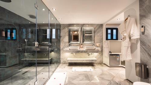 a bathroom with two sinks and a shower at Riad Maison Bleue and Spa in Fez