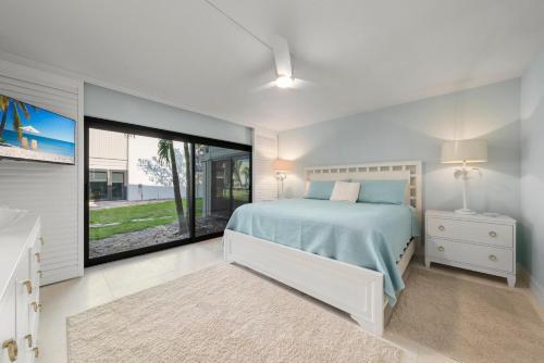 a bedroom with a bed and a large window at Mariner Pointe #521 in Sanibel