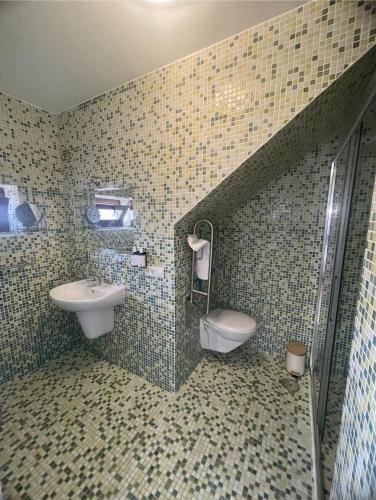a bathroom with a sink and a toilet at Corrubedo Beach Lodge in Corrubedo