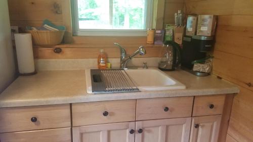 a kitchen sink with a laptop on top of it at Chalet Cabin 7-Acres Pond! in Andover