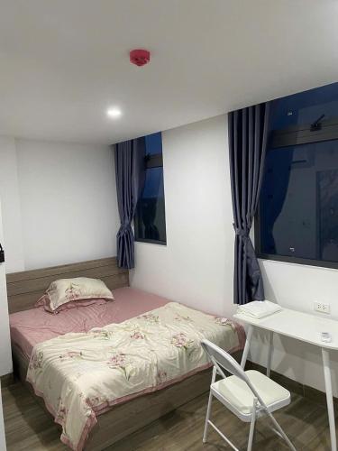 a bedroom with a bed and a table and a chair at Thien Khanh Hotel for rent in Danang