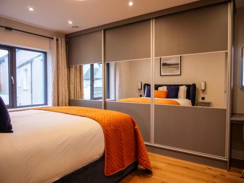 a bedroom with a large bed and a large closet at Dingle Doorstep - Town Centre in Dingle
