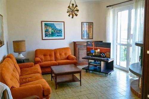 a living room with a couch and a table at Casa Mariarosa in Maccagno Inferiore