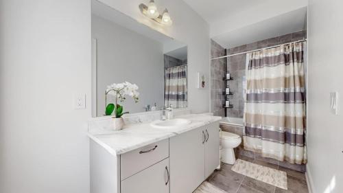 a white bathroom with a sink and a toilet at Modern-Detached 5 Bedroom100 Spotless-Sleeps 13 in Caledon East