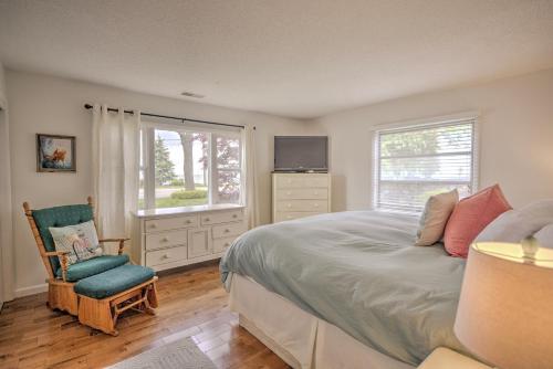 a bedroom with a bed and a chair and a television at Lake Views & Fire Pit in South Haven