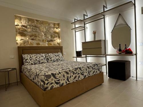 a bedroom with a large bed and a mirror at Romantico bilocale ad Ortigia in Syracuse