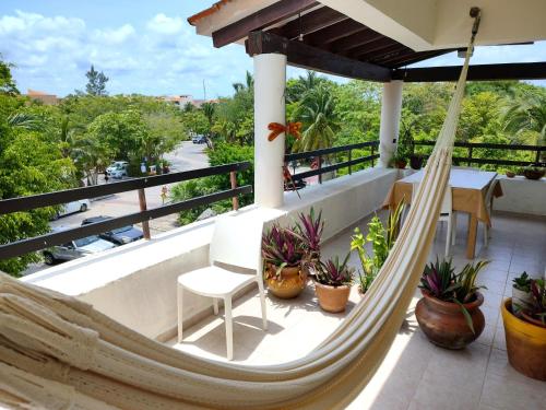 a hammock on the balcony of a house at Beautiful apartment, prime location, beach 2 minutes away in Puerto Aventuras
