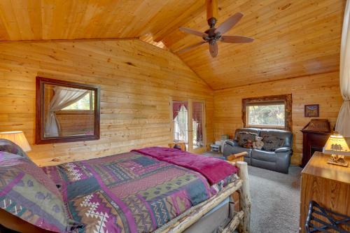 a bedroom with a bed and a ceiling fan at 3-Cabin Base w/ Lake Access: Dogs Welcome! in Soldotna