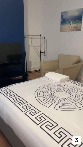 a bed in a room with a couch at PLUS Properties Oxford 3 in Stoke on Trent