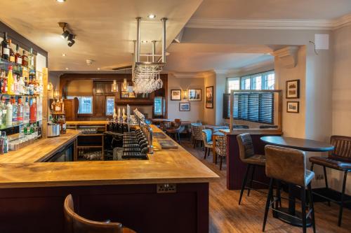 a bar in a pub with chairs and tables at Colwall Park - Hotel, Bar & Restaurant in Great Malvern