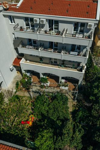 an overhead view of a large white building with a red roof at Apartments Nada in Petrovac na Moru