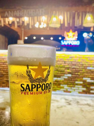 a glass of beer sitting on a table at Ana resort Phu Yen in Liên Trì (4)