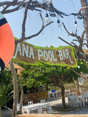 a sign for an na polo bar with chairs and trees at Ana resort Phu Yen in Liên Trì (4)
