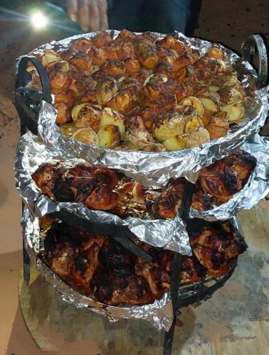 two trays of food in tin foil on a table at Leen Luxury Camp in Disah