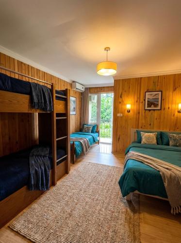 a bedroom with three bunk beds and a rug at TA-mari in Ureki