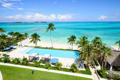 an aerial view of a resort with a swimming pool and the ocean at Cable Beach condo with ocean views in Nassau