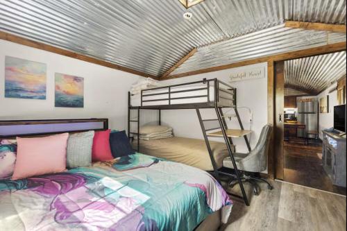 a bedroom with a bunk bed in a room at Red River Gorge Creekside Cabin, Hot Tub, Shared Bathhouse in Stanton