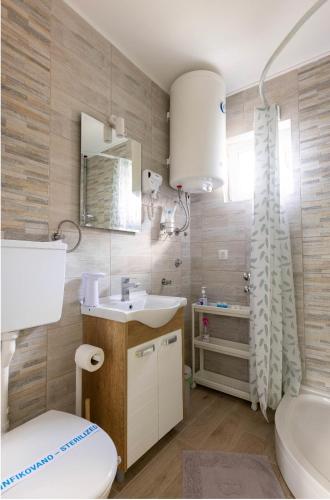 a bathroom with a white toilet and a sink at Charlie&Blueberries 1 in Belgrade