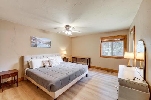 a bedroom with a bed and a ceiling fan at Columbia Falls Private Retreat: Pool Table & Deck! in Columbia Falls