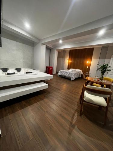 a large living room with a tub and a bed at Hotel Atenas in Barranca