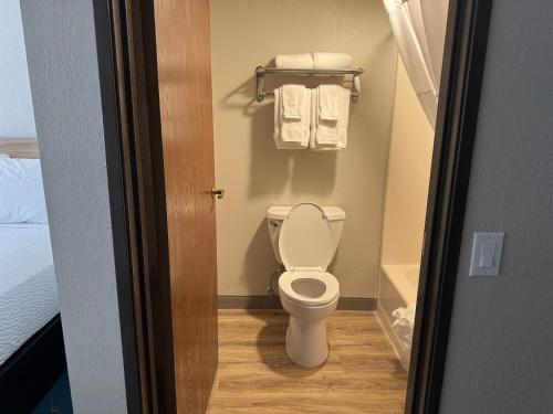 a small bathroom with a toilet and towels at Days Inn by Wyndham Sault Ste Marie MI in Sault Ste. Marie