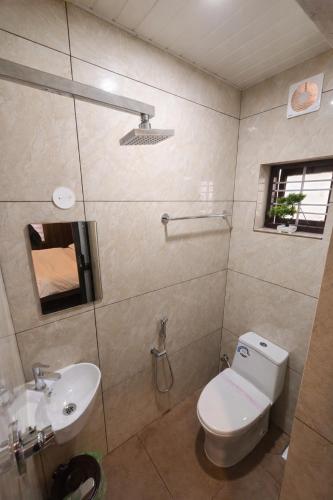 a bathroom with a toilet and a sink at The VARKALA HAVEN 105 in Varkala