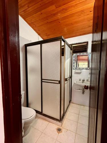 a bathroom with a toilet and a sink at Finca en La Cumbre in La Cumbre