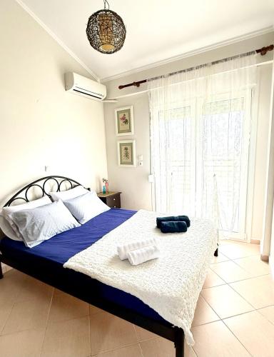 a bedroom with a large bed with blue and white sheets at SEASIDE MAISONETTE in Aroyí
