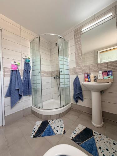 a bathroom with a shower and a sink at SEASIDE MAISONETTE in Aroyí