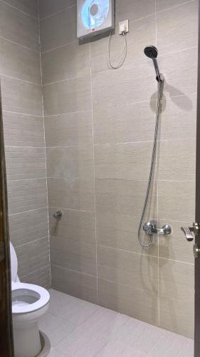 a bathroom with a shower with a toilet at شاليه الجاكرندا 8 in Taif