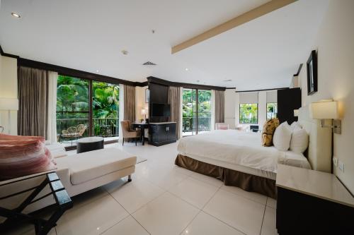a large bedroom with a large bed and a living room at The Royal Corin Thermal Water Spa & Resort - Adults Only in Fortuna