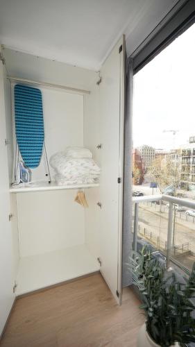 a room with white walls and a large window at Anvers Apartment in Antwerp
