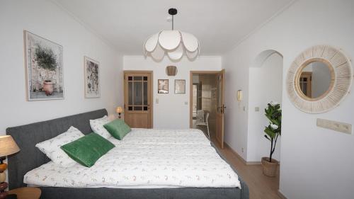 a bedroom with a large bed with green pillows at Anvers Apartment in Antwerp
