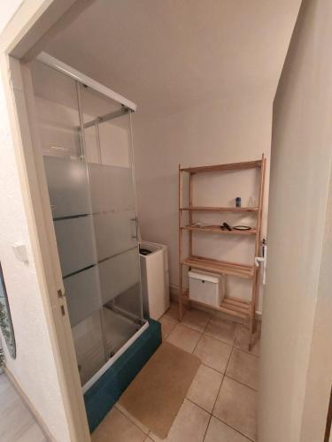 a bathroom with a glass shower and a toilet at Studio petite perle in Bargemon