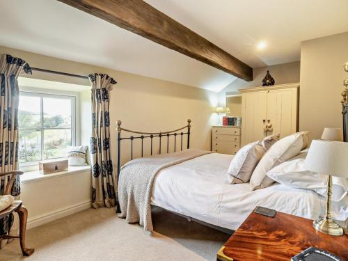 a bedroom with a large bed and a window at 2 Bed in Wincle oc-pk298 in Windley