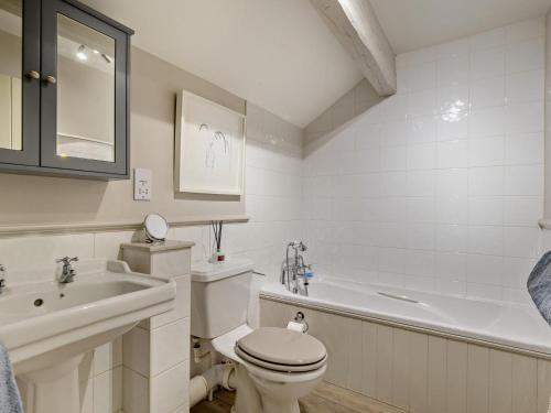 a bathroom with a toilet and a sink and a tub at 2 Bed in Wincle oc-pk298 in Windley