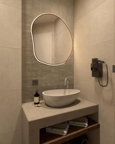 a bathroom with a sink and a mirror at NOEMA Fanari in Fanari