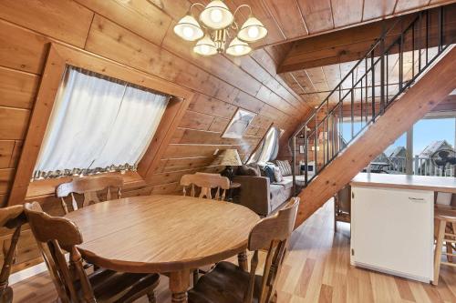 a dining room with a wooden table and chairs at Chalet #29 in Stevensville