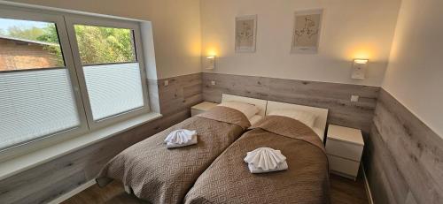 a bedroom with a bed with two pillows on it at Gästehof Bützfleth in Stade