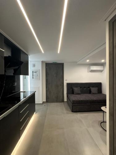 a living room with a couch and a kitchen at Golden Ecco Suites in Nafpaktos