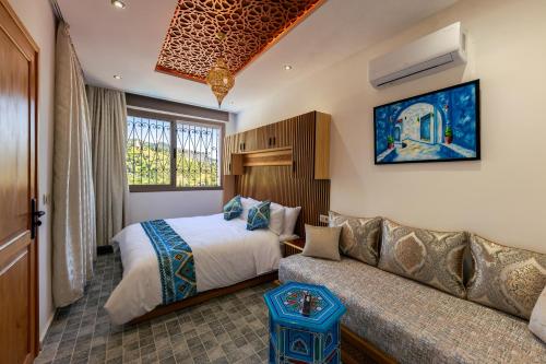 a hotel room with a bed and a couch at Riad Seddiki in Chefchaouen